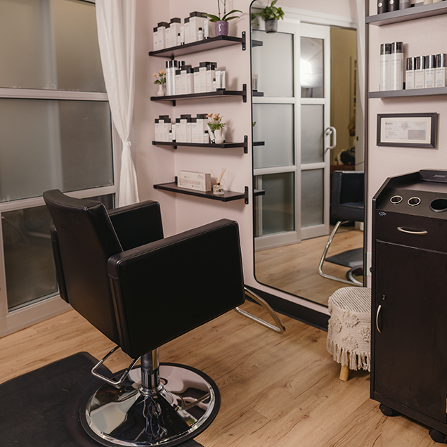 Hair Stylist Amy Soundara rinsing a woman's hair